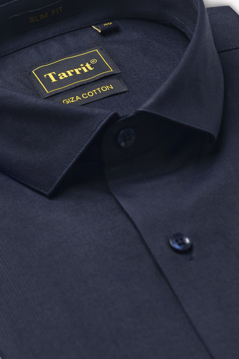 Close-up of Egyptian cotton shirting fabric held to the light showing fine two-fold yarn and a smooth low-fuzz weave